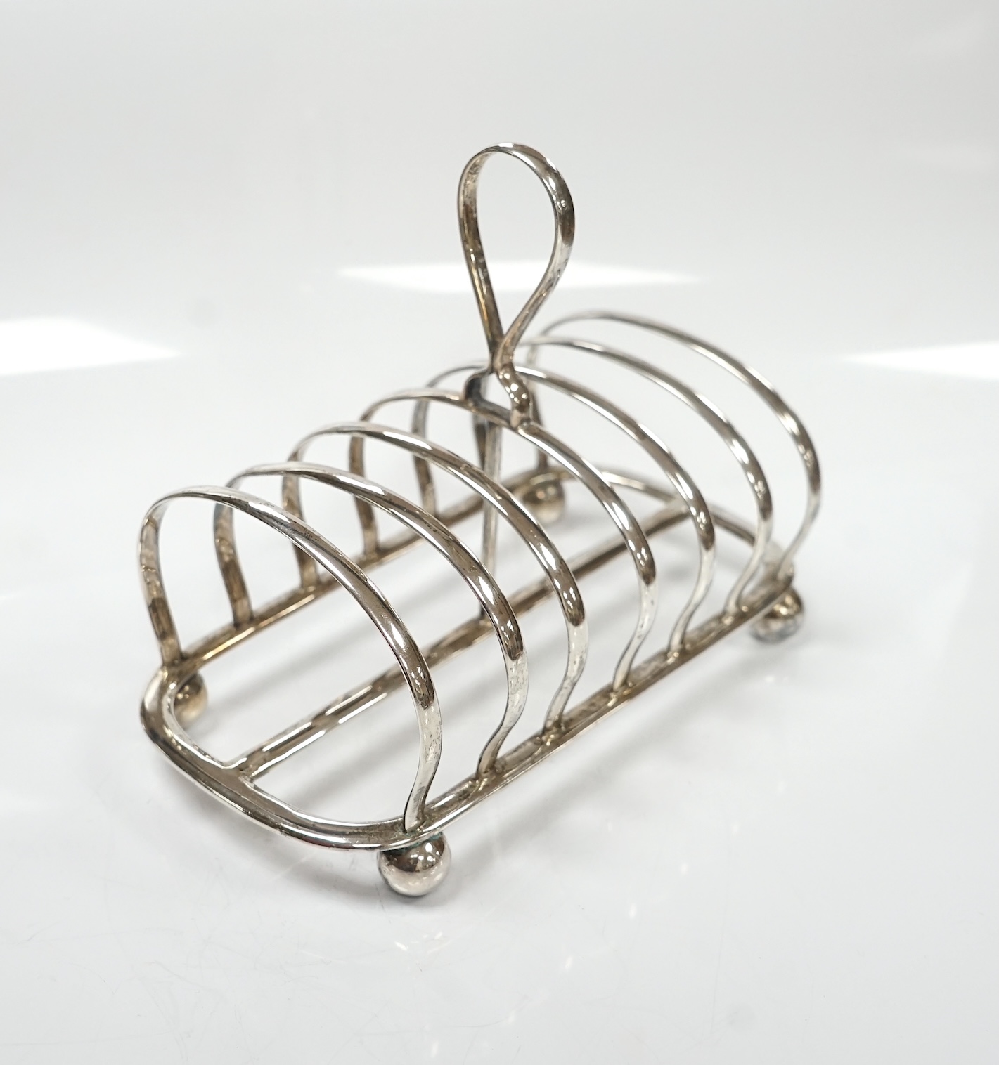 A George V silver seven bar toast rack, by Mappin & Webb, Sheffield, 1913, length 15cm, 7.3oz. Condition - fair to good